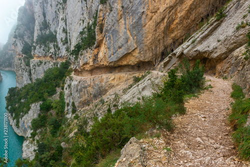 Path excavated in the rock allows to cross Congost de Mont-Rebei defile, border between Catalonia and Aragon, Spain