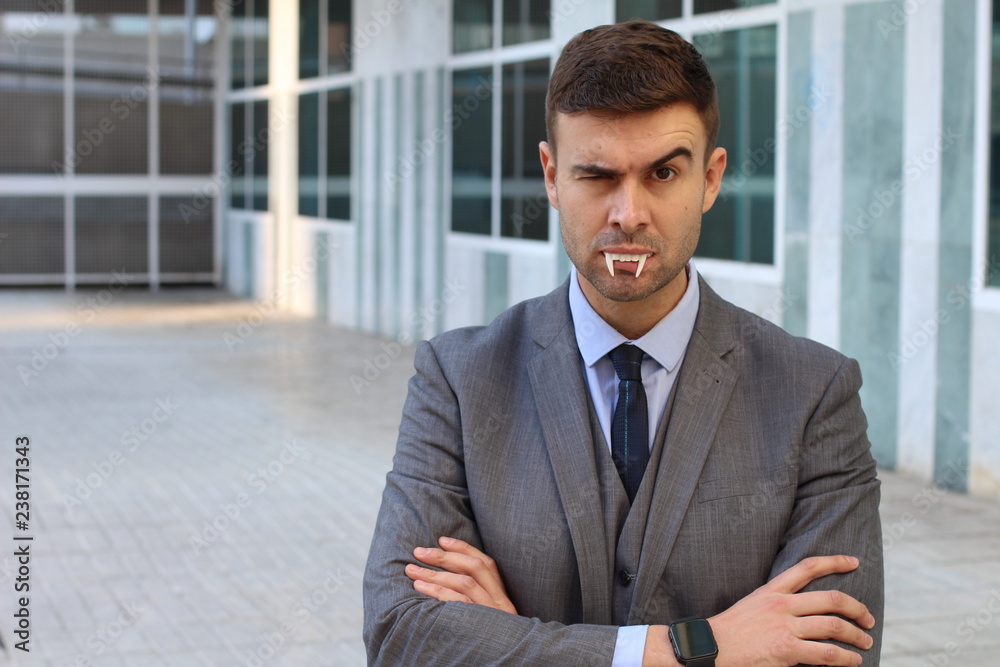 Businessman with vampire fangs in the office Businessman with vampire fangs in the office