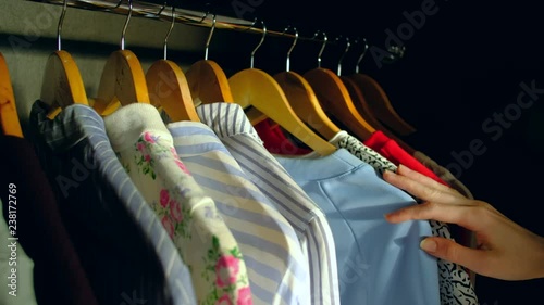 Closeup - Female Woman cchooses clothes for a business meeting. hooses clothes in the wardrobe. photo