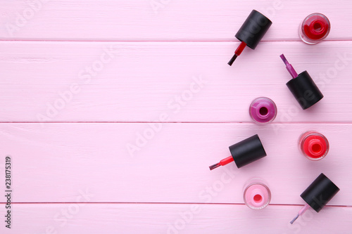 Fototapeta Naklejka Na Ścianę i Meble -  Group of bright nail polishes on pink