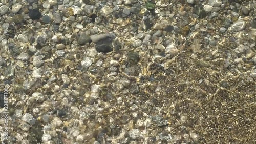 abstract background from light refraction of water and pebble on bottom with rreflections photo