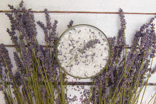 Natural herbal sea salt with aromatic lavender - perfect for relaxation. Cosmetic jars and bottles with salt, lavender flowers, bath bomb