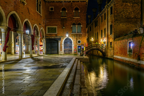 Narrow canal with bridge in Venice  Italy. Architecture and landmark of Venice. Night cozy cityscape of Venice.