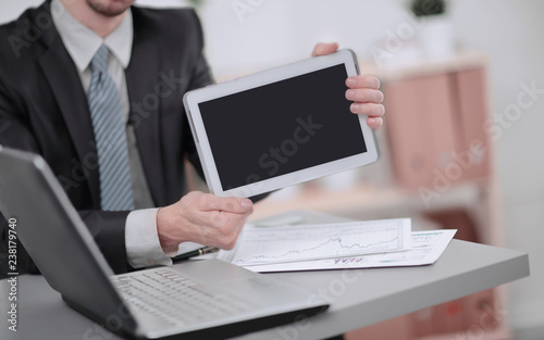 close up.businessman showing tablet with blank screen