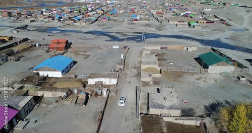 ​4k 60 fps Mongolia Aerial view of Altai city following 4x4 driving in - towar river incity center photo