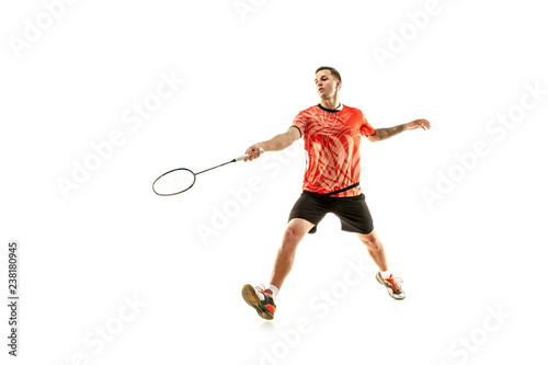 Young man playing badminton over white studio background. Fit male athlete isolated on white. badminton player in action, motion, movement. attack and defense concept © master1305