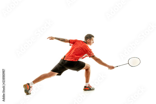 Young man playing badminton over white studio background. Fit male athlete isolated on white. badminton player in action, motion, movement. attack and defense concept © master1305