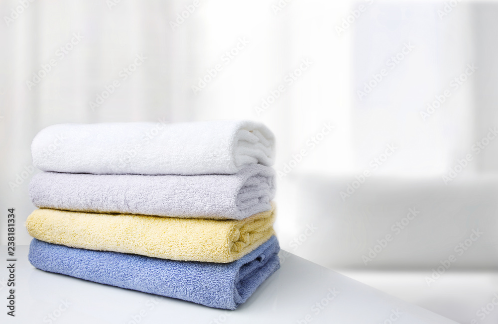 Stack of towels white room empty space background.