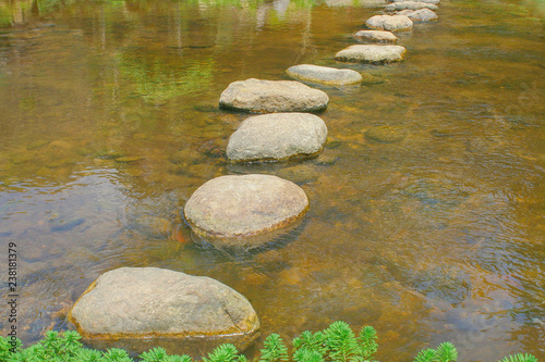 Rock walkway lines patterns in  water river outdoor background © Amphawan