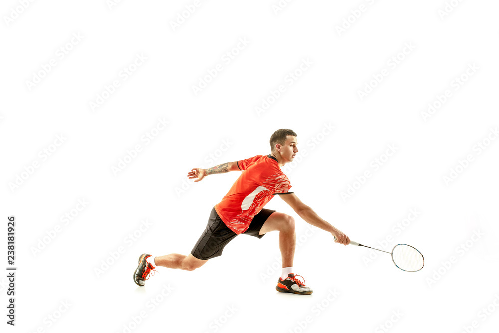 Young man playing badminton over white studio background. Fit male athlete isolated on white. badminton player in action, motion, movement. attack and defense concept