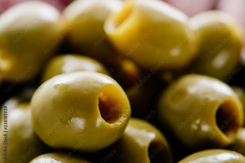 close up view of tasty green pitted olives close up view of tasty green pitted olives