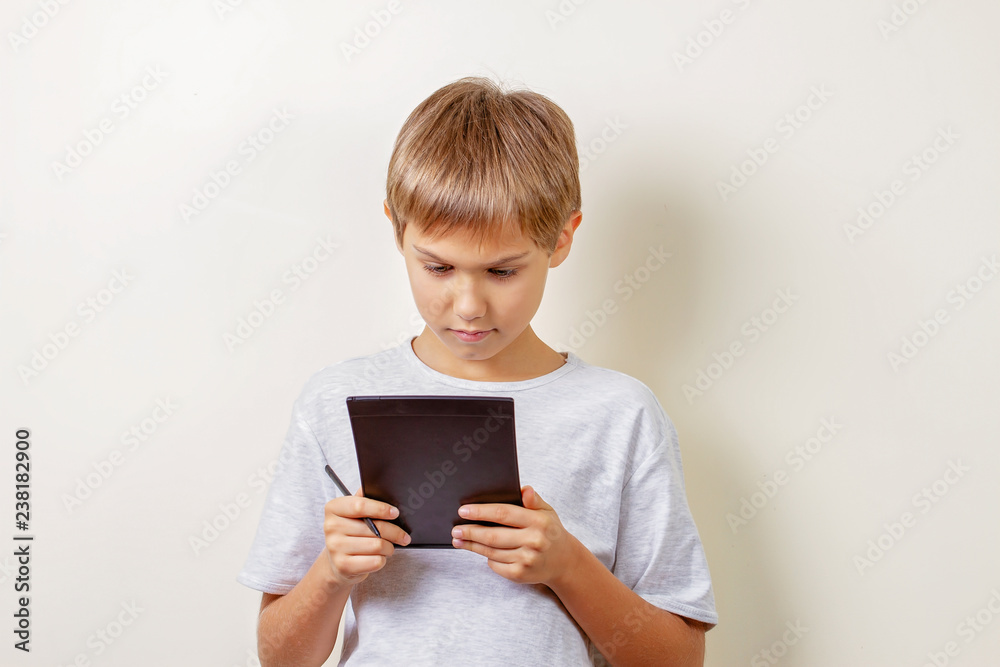 Kid drawing with graphic tablet and stylus pen Kid drawing with graphic tablet and stylus pen