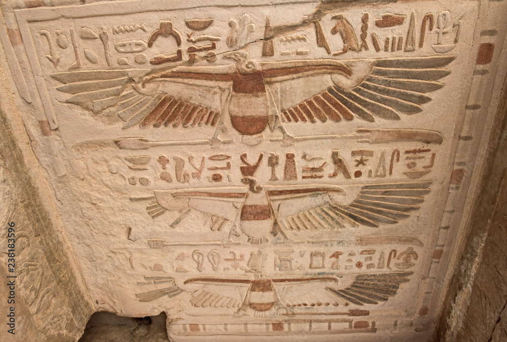 Painted hieroglyphic carvings on an ancient egyptian temple wall