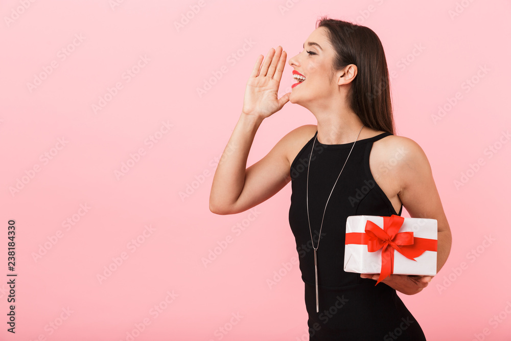 Fototapeta premium Portrait of a beautiful young woman wearing black dress
