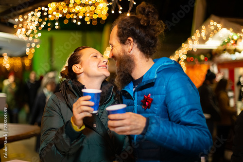 Couple kissing and enjoying traditional Christmas market, Zagreb, Croatia.