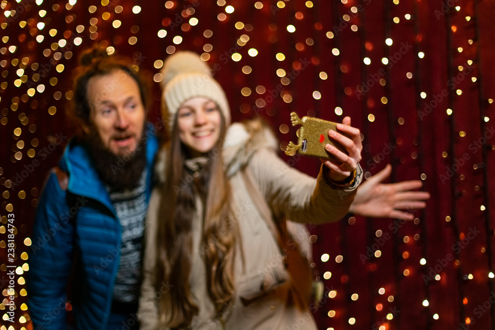 Father and daughter taking selfie at Christmas market.