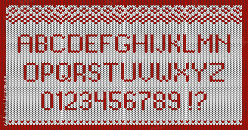 White knitted fabric with a red ornament,  letters and numbers.
