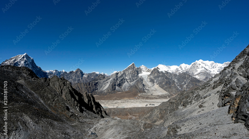 View towards Khumbu Glacier and Lobuche town from Kongma La Pass. At the top of Kongma La high mountain pass in Khumbu Region of Nepal. Expansive views towards North, glacier crossing and Lobuche town