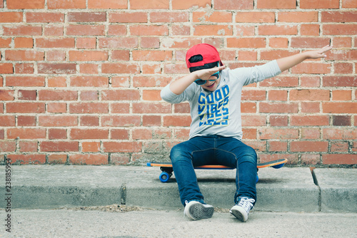 child with skateboard in the street