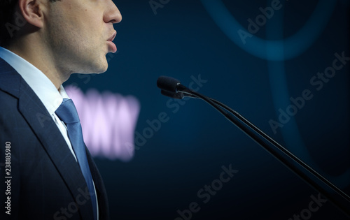 Speaker at business conference and presentation.