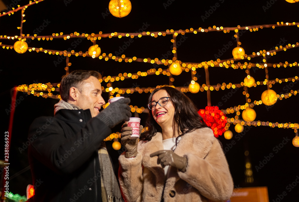 Couple cheering with mlled wine at Christmas market. Zagreb, Croatia.