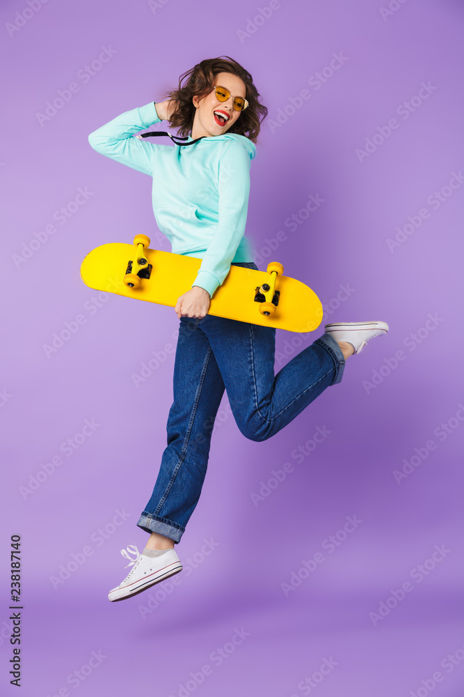 Fototapeta premium Beautiful young woman posing isolated over purple background wall.