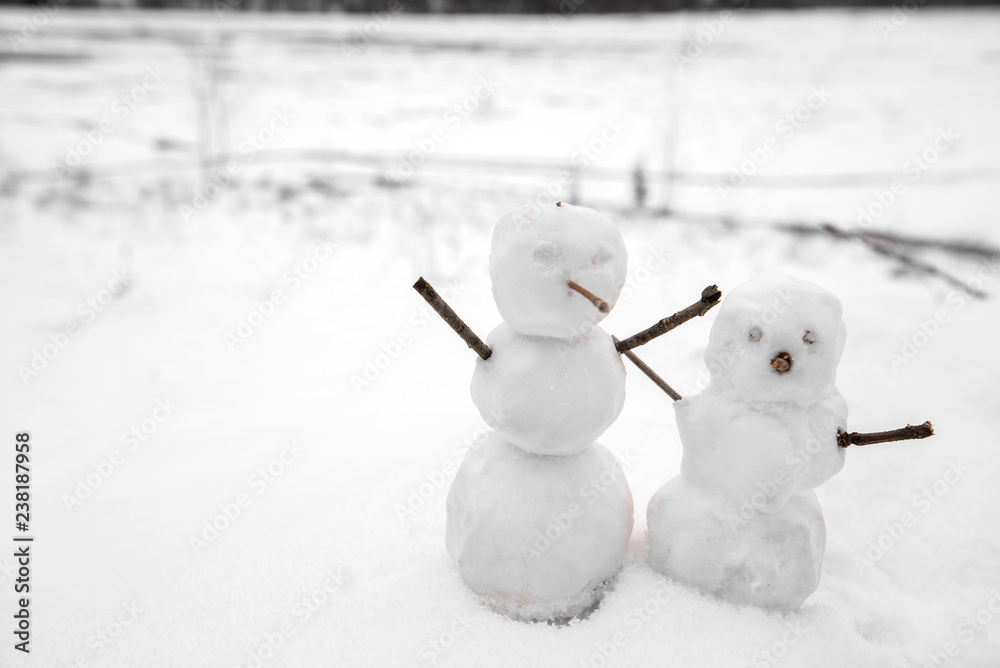 Two real tiny, little snowman in nature in snowy, cold day in mountains. Concept of beautiful winter and kids or family having fun on holidays. Merry Christmas. Two real tiny, little snowman in nature in snowy, cold day in mountains. Concept of beautiful winter and kids or family having fun on holidays. Merry Christmas.
