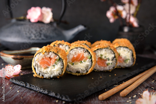 Hot fried Sushi Roll with salmon, avocado and cheese. Sushi menu. Japanese food.