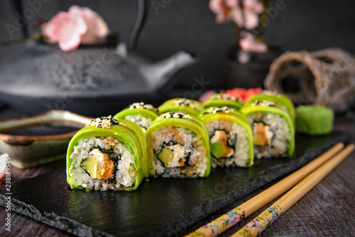Vegetarian sushi rolls avocado with cream Philadelphia cheese, sesame, unagi sauce. Sushi menu. Japanese food. 