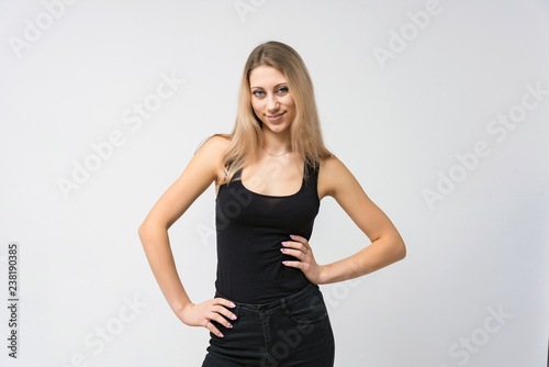 Concept portrait of a beautiful blonde girl smiling on a white background advertises product. She is right in front of the camera and shows different emotions.