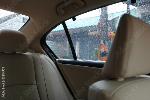 back seat inside vehicle car with rain drop on window © sutichak