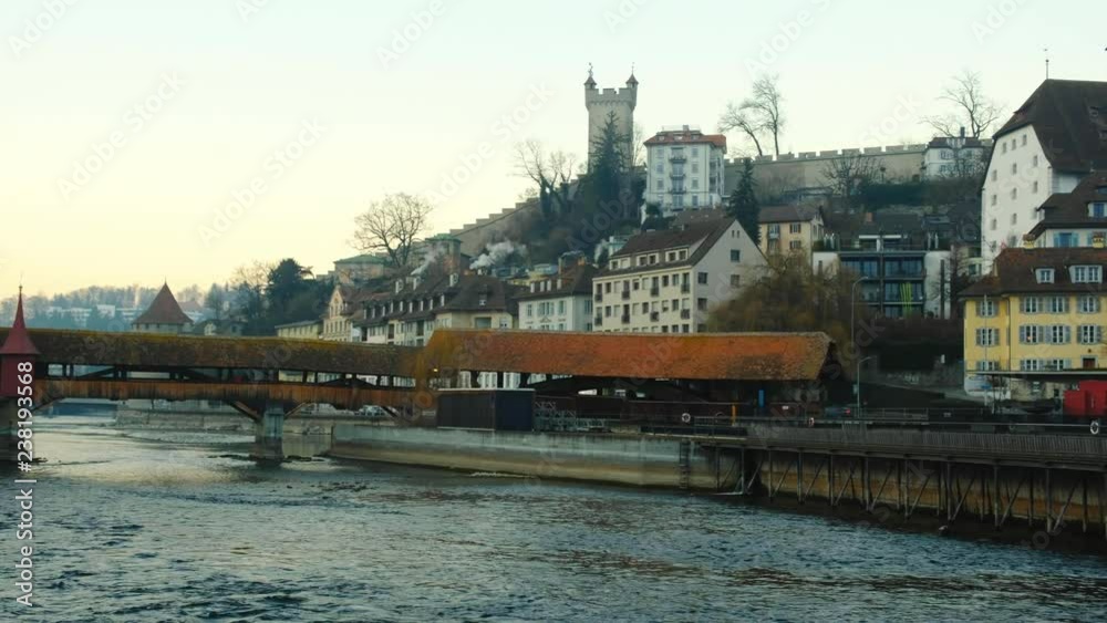 Kapellbrucke panorama view of Chapel bridge, Water Tower, Chateau, flowing Reuss river in Lucerne, Switzerland. Christmas holidays in Europe. Cityscape of European old town Luzern with lake stream. Kapellbrucke panorama view of Chapel bridge, Water Tower, Chateau, flowing Reuss river in Lucerne, Switzerland. Christmas holidays in Europe. Cityscape of European old town Luzern with lake stream.