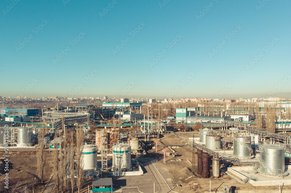 Aerial panoramic view of industrial factory or plant buildings with steel storage construction tanks and pipes, industry landscape background with copy space