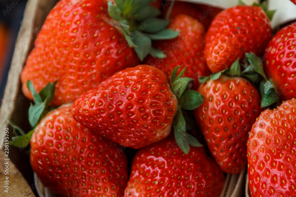 fresh, red, green strawberries are packed in baskets fresh, red, green strawberries are packed in baskets