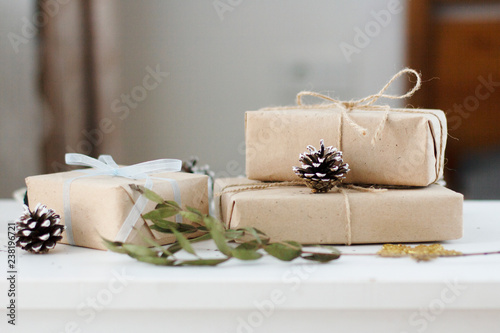 boxes wrapped in Kraft paper with gifts beautifully laid out and decorated with Christmas decorations in the interior