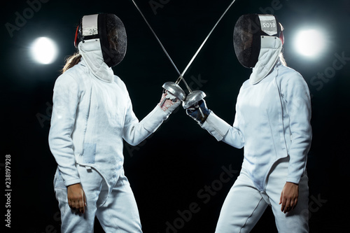 Fotografie Young fencer athlete wearing mask and white fencing costume