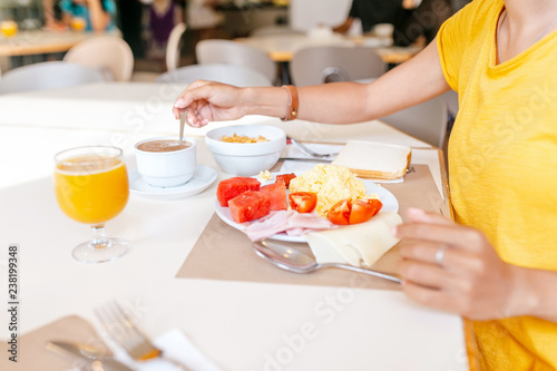 woman eating breakfast in hotel buffet