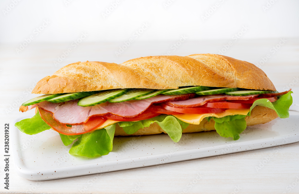 sandwich with ham, cheese, tomatoes, cucumbers, lettuce on white background sandwich with ham, cheese, tomatoes, cucumbers, lettuce on white background