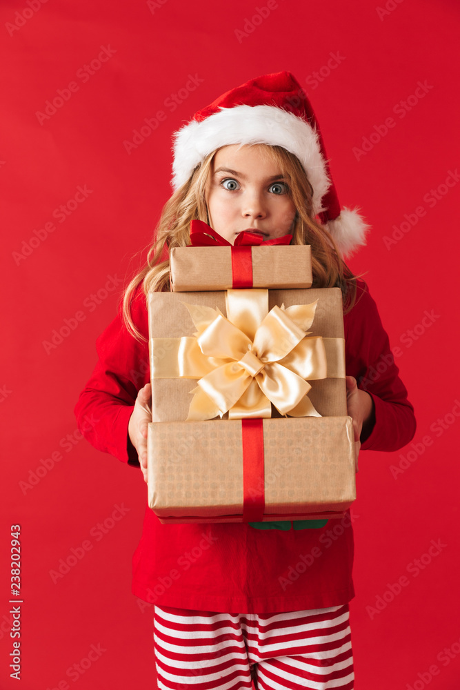 Pretty little girl wearing Christmas hat standing Pretty little girl wearing Christmas hat standing