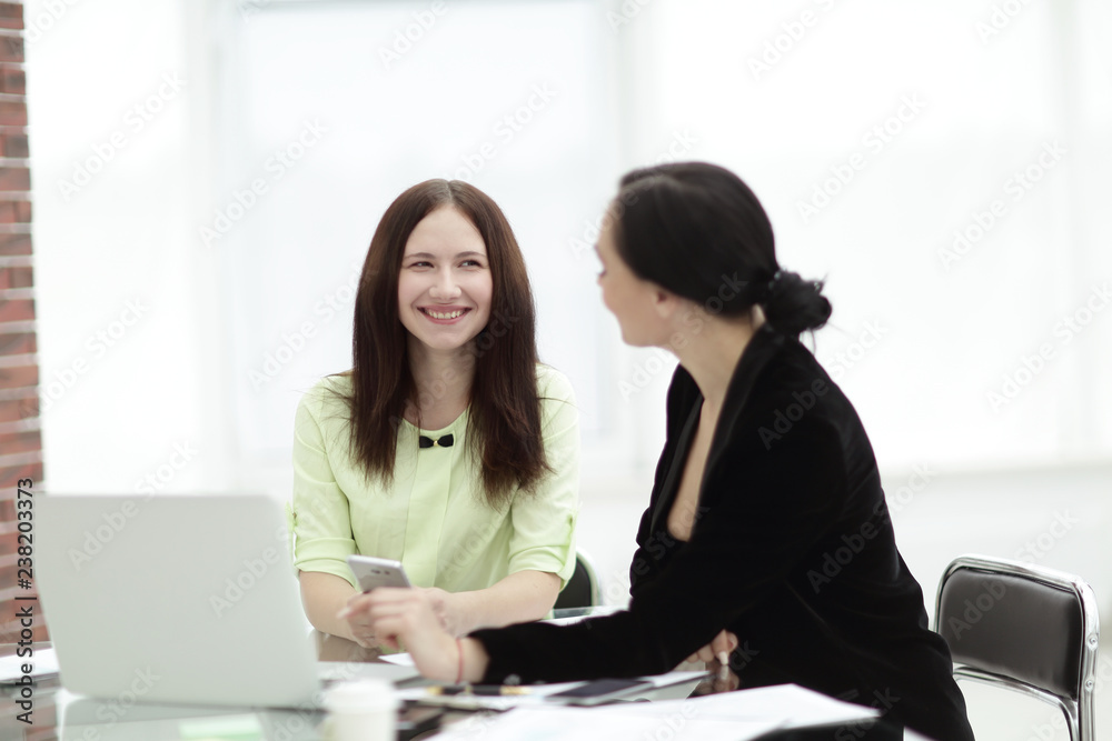 close up. business women and assistant discussing work issues in the office close up. business women and assistant discussing work issues in the office