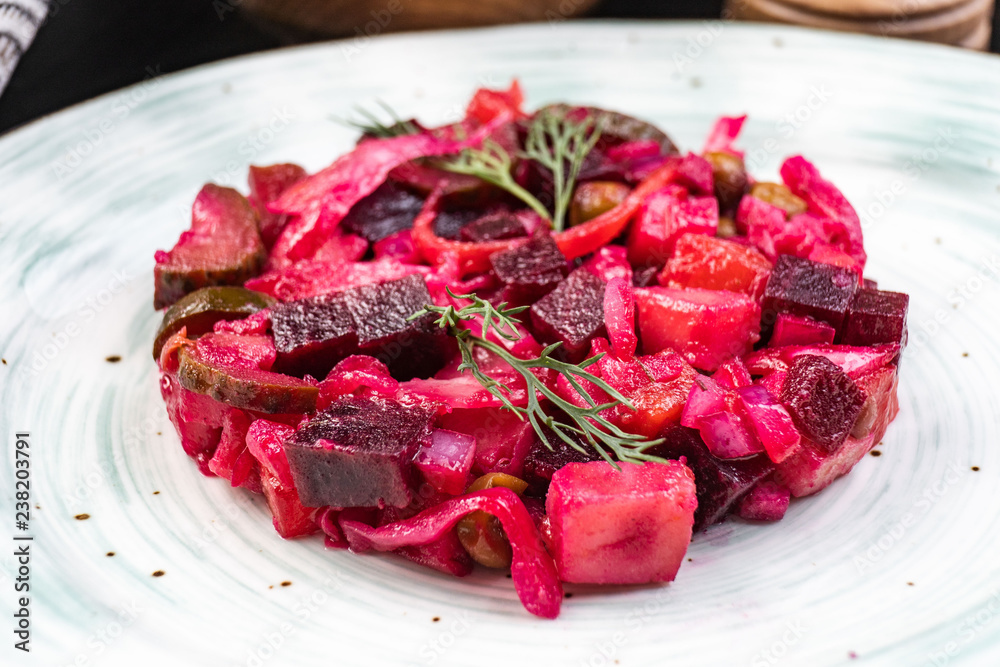 Salad from the beet. Vinaigrette is a traditional Russian salad made from beets and vegetables. Three bowls with salad.
