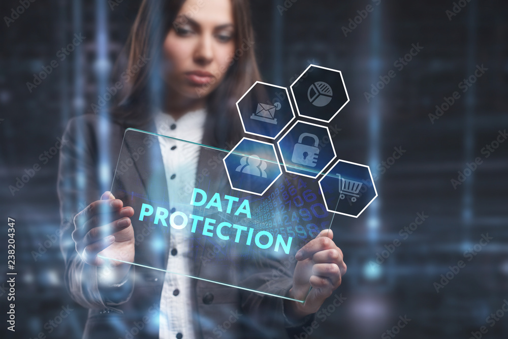 The concept of business, technology, the Internet and the network. A young entrepreneur working on a virtual screen of the future and sees the inscription: Data protection The concept of business, technology, the Internet and the network. A young entrepreneur working on a virtual screen of the future and sees the inscription: Data protection