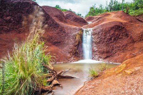 A small red dirt waterfall  in the Waimea Canyon on Kauai