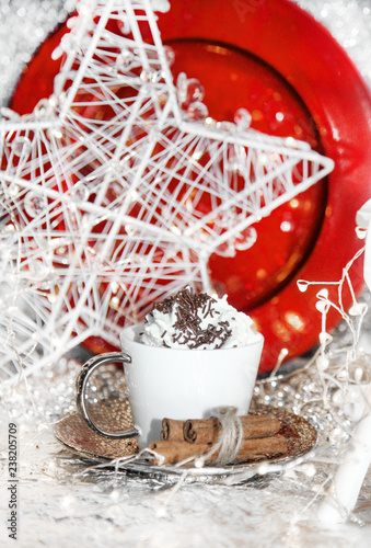 Christmas red and white, xmas reindeer, cup of whipped cream, red plate, christmas balls, winter cone on white background, with lights, sweets, cinnamon