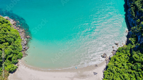 Aerial view amazing white sandy beach with turquoise water in tropical country. Amazing top view of sandy tropical beach, Palm and tropical beach with crystal clear water.