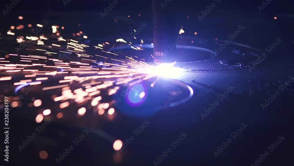 Metal sheet cut by machine at workshop. Close up Modern CNC plasma cutting machine in heavy industry. High precision manufacture of steel parts. Computer Automation of process. Automatic ironwork