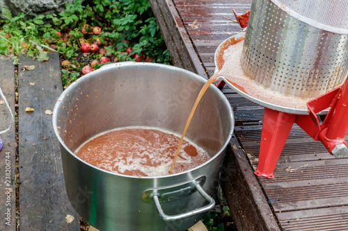 people push apple juice with an apparatus