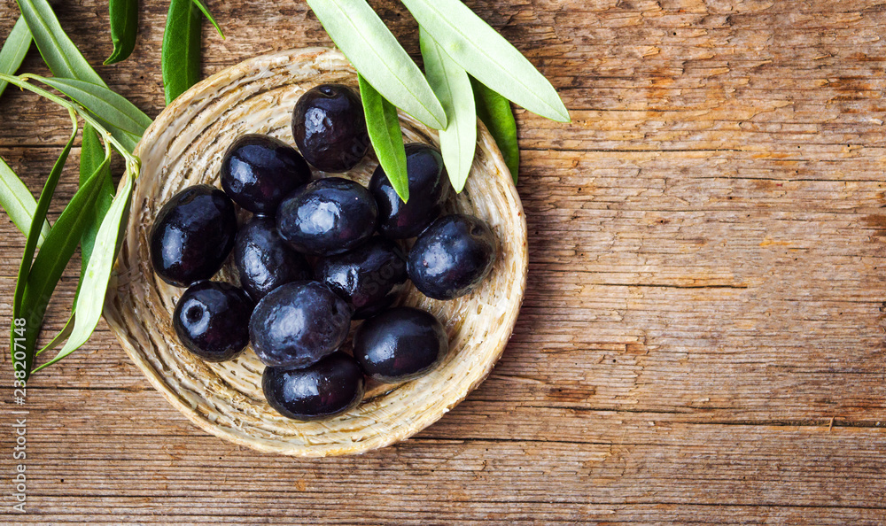 Dark olives on a wooden table