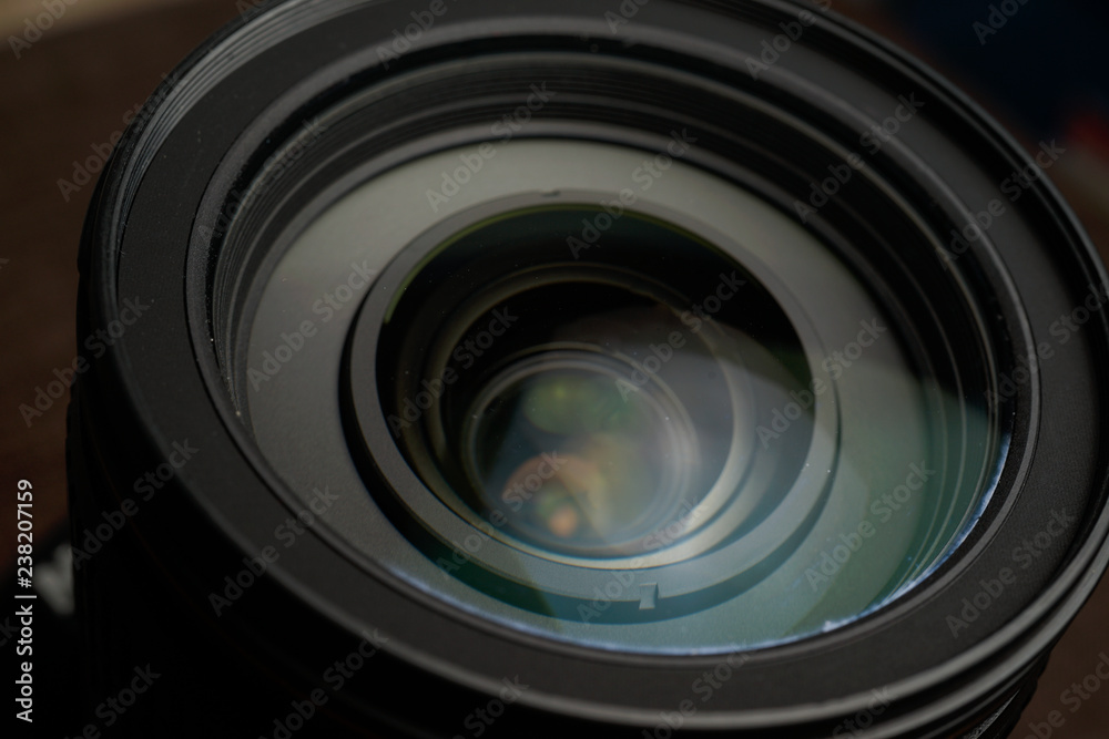 Close up of modern digital camera lense, a view of the front lens with flare effects Close up of modern digital camera lense, a view of the front lens with flare effects