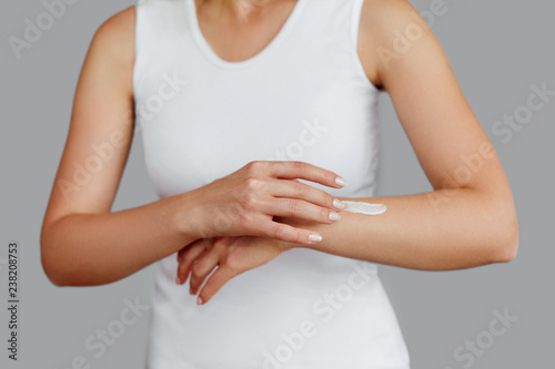 Wallpaper Mural Closeup shot of woman hands holding cream and applying moisturizing hand cream. Beautiful female hands with cream. Hand Skin Care. A woman uses body lotion on your arms. Beauty And Body Care Concept Torontodigital.ca